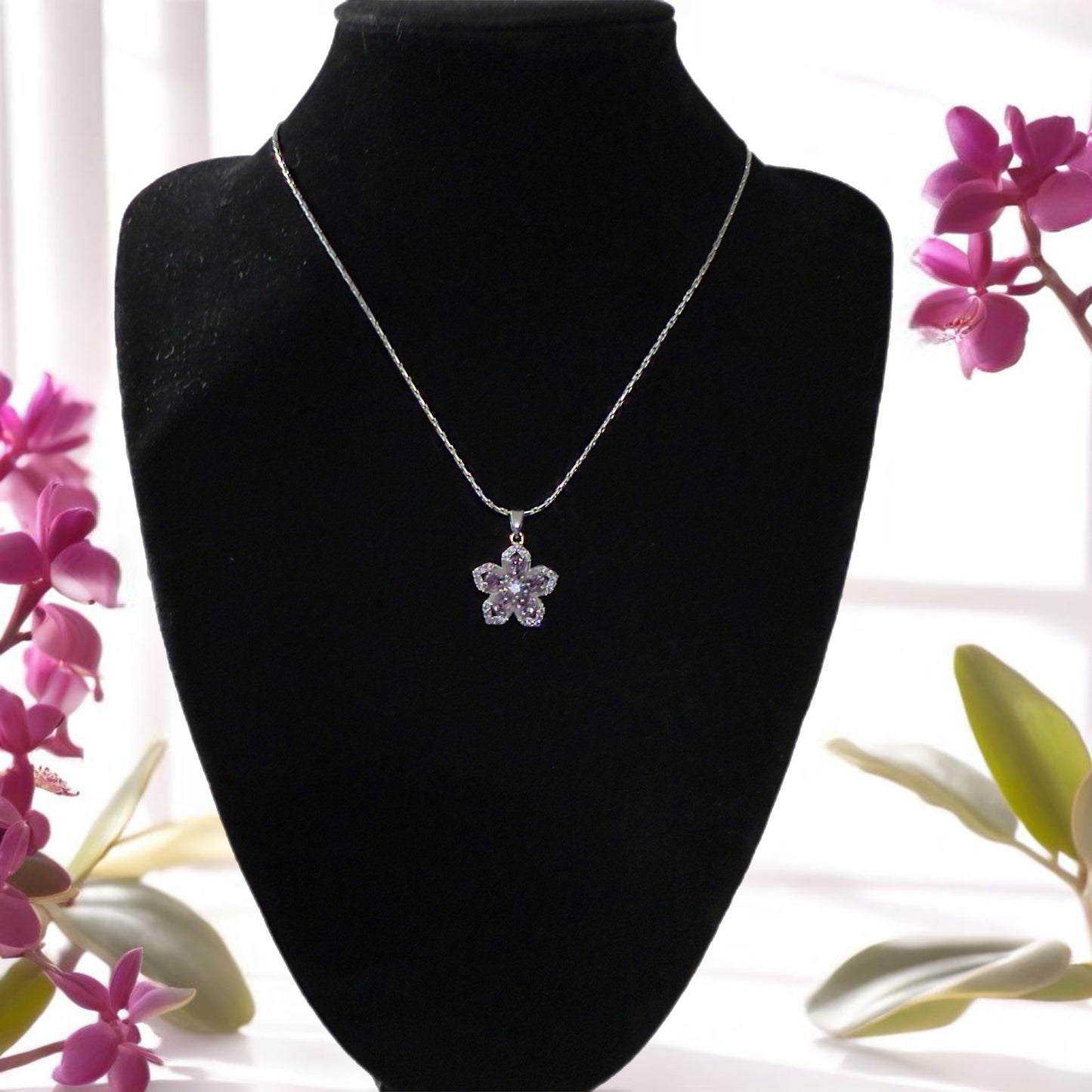 Silver flower pendant necklace.